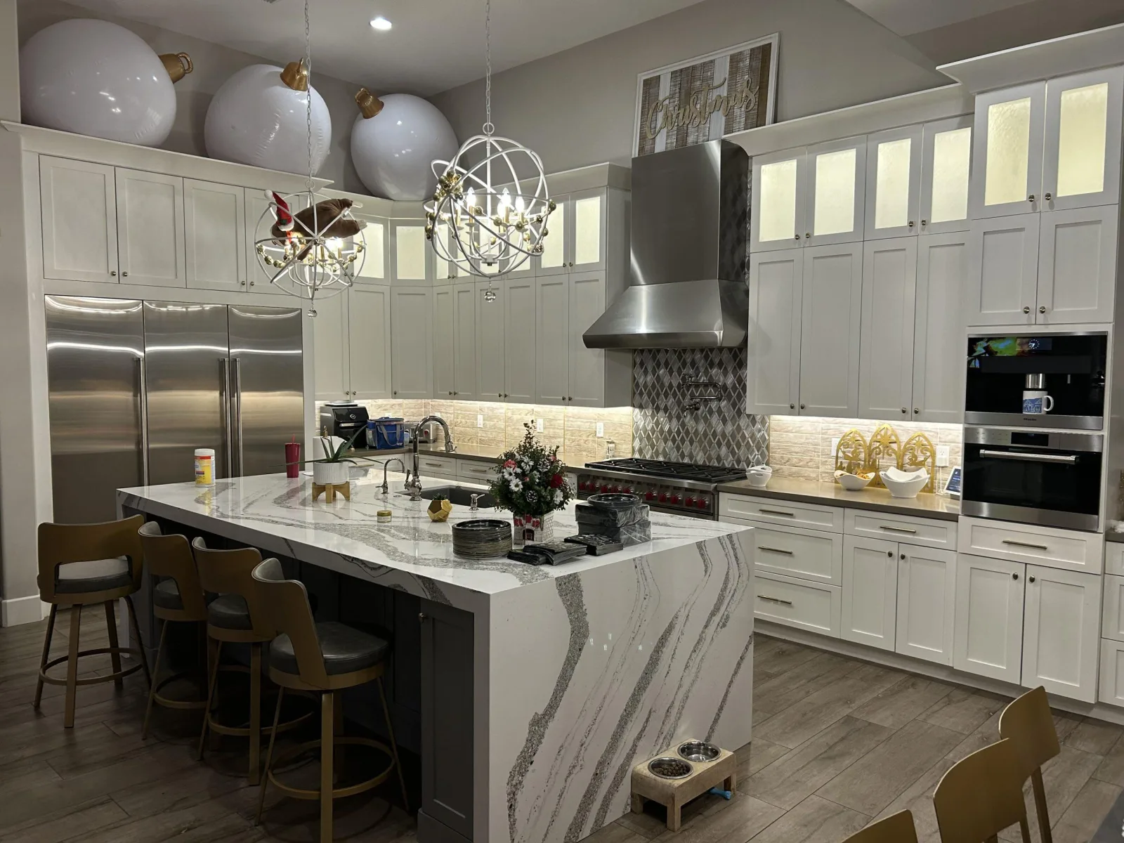 White shaker kitchen with a Cambria quartz island and waterfall edge